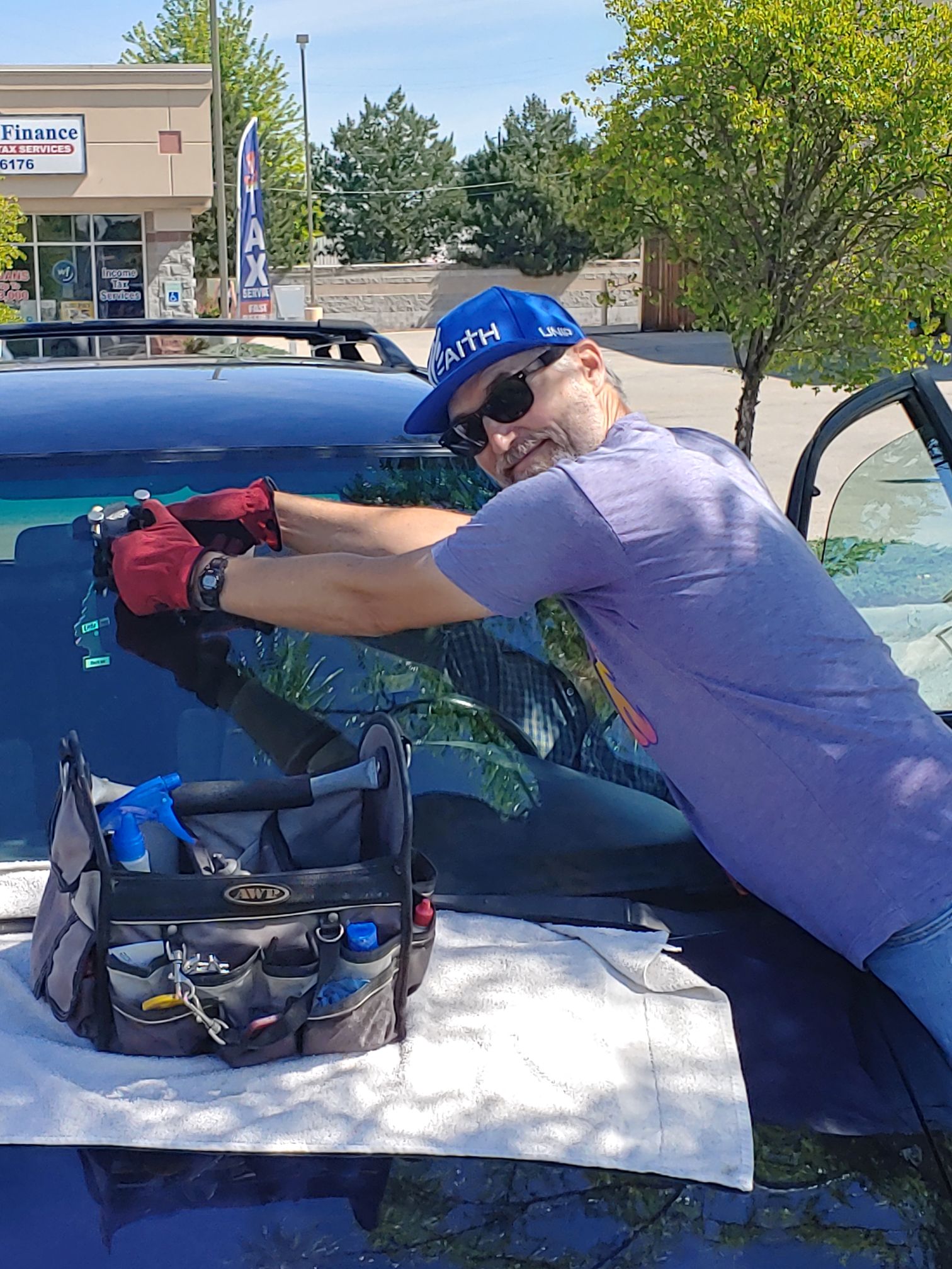 Precision Auto Glass technician repairing a rock chip on a vehicle windshield