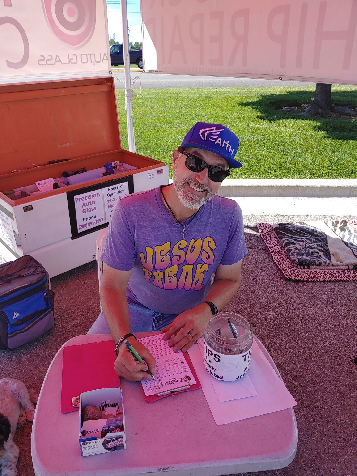 Precision Auto Glass technician repairing a vehicle windshield under service kiosk